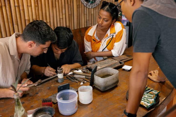 Tourists in Bali observing silver making class