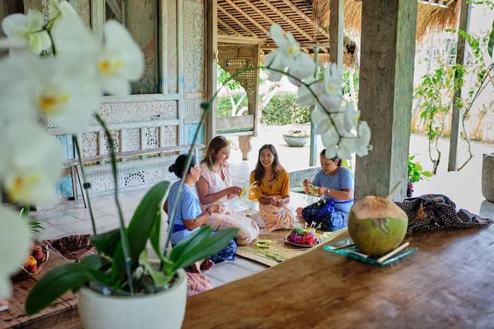 Tourist in Bali learning how to weave traditional craft