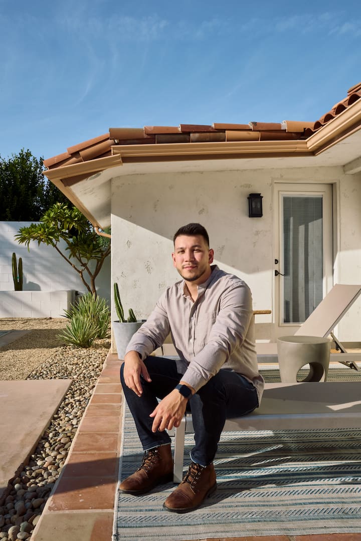Jimmy Repp, an Airbnb.org host, housed LA wildfire evacuees and sits in front of his Airbnb.
