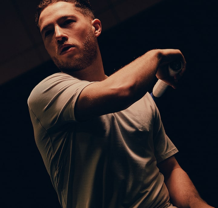 A focused shot of an arm gripping a tennis racket, highlighting the action and intensity of the moment.