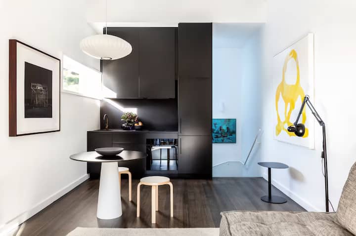 Modern dining nook with black cabinetry and minimalist decor.