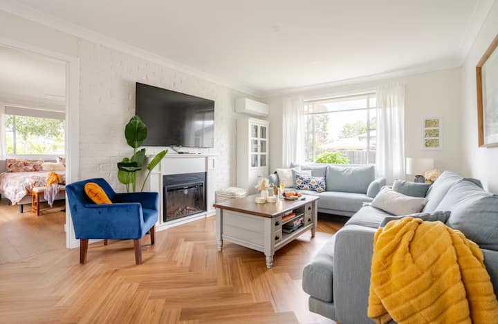 Cozy living room with sofas and fireplace.