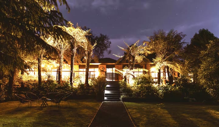 House with garden lights at night.
