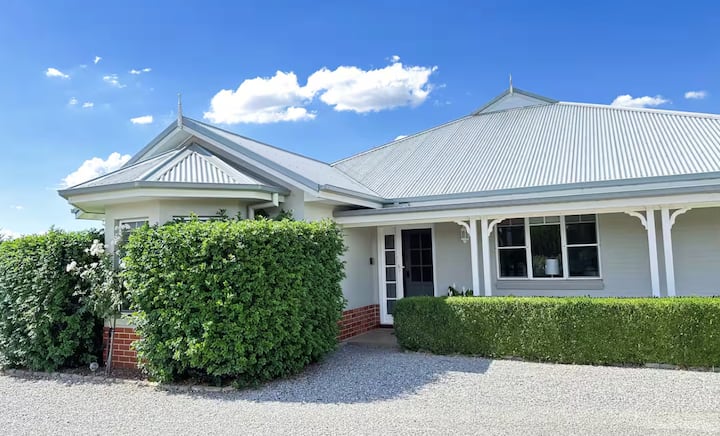 White country house with metal roof