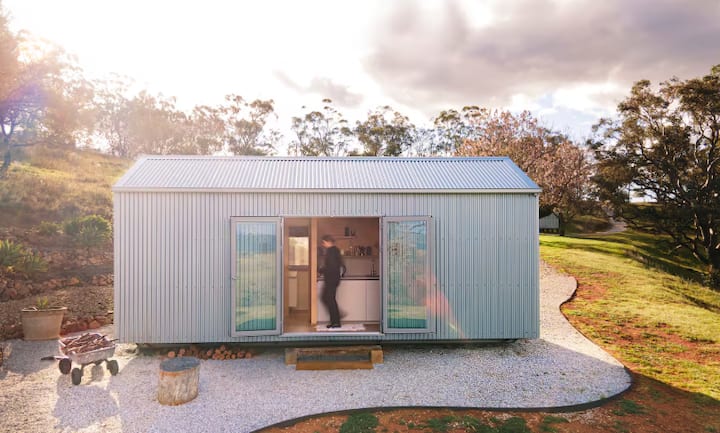 Small corrugated metal cabin in countryside