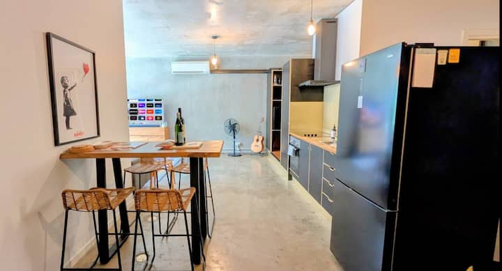 Modern kitchen with high table and stools