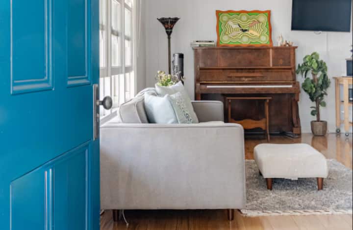 Living room with sofa and upright piano