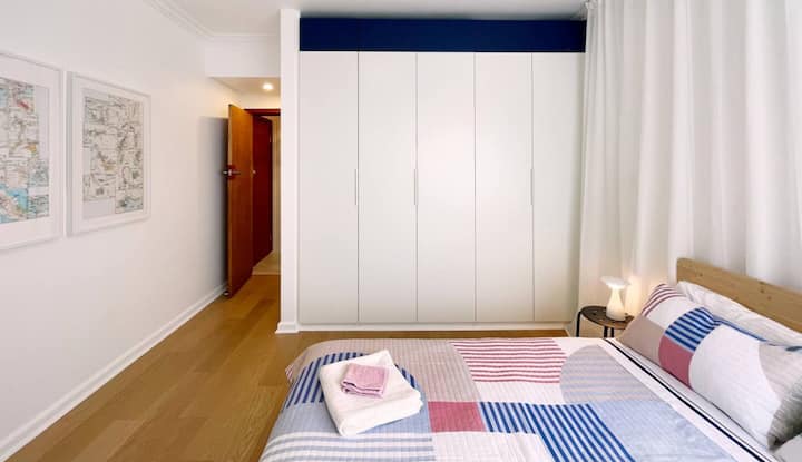Bedroom with wardrobe and patterned bedding