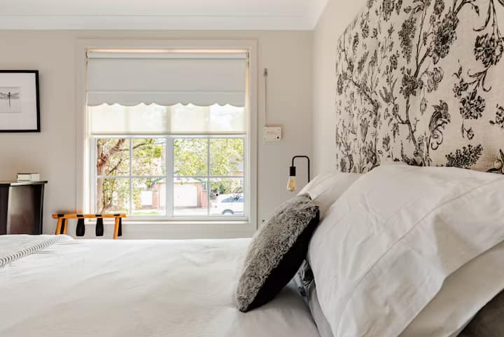 Bedroom with floral headboard and window view