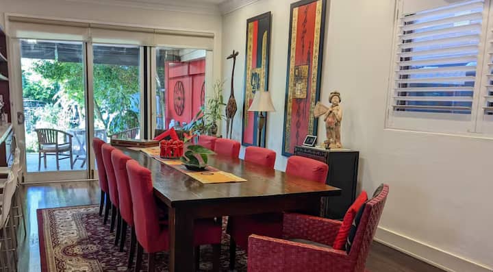 Dining room with red chairs and Asian-inspired decor