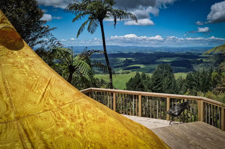 Scenic deck with yellow tent and sweeping valley views