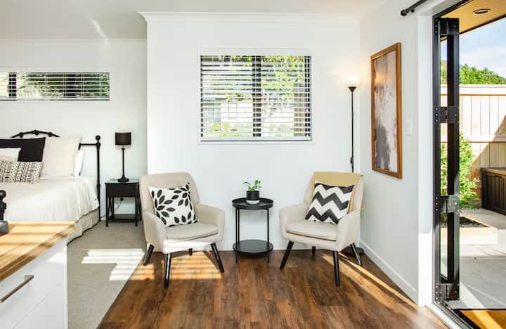 Bright sitting area with chairs and indoor-outdoor flow