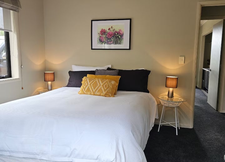 Cozy bedroom with white bedding and yellow accents