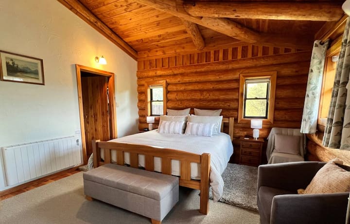 Cozy log cabin bedroom with wooden beams
