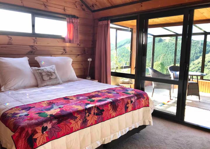 Bedroom with mountain view and colorful blanket
