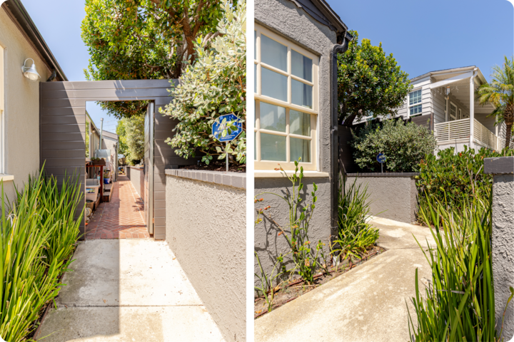 Allée ensoleillée menant à un patio confortable en passant sous une arche en bois, entouré d'une végétation luxuriante et de bâtiments gris modernes.