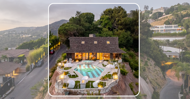 Une villa à flanc de colline au crépuscule avec une piscine au sol rayé entourée de chaises longues blanches et de parasols, entourée par une végétation luxuriante et des logements modernes en arrière-plan.
