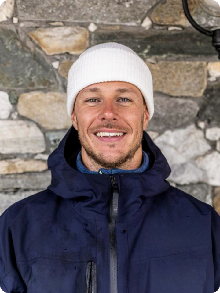 Paralympic Jacopo Luchini snowboarding on a mountain in a team Italy uniform