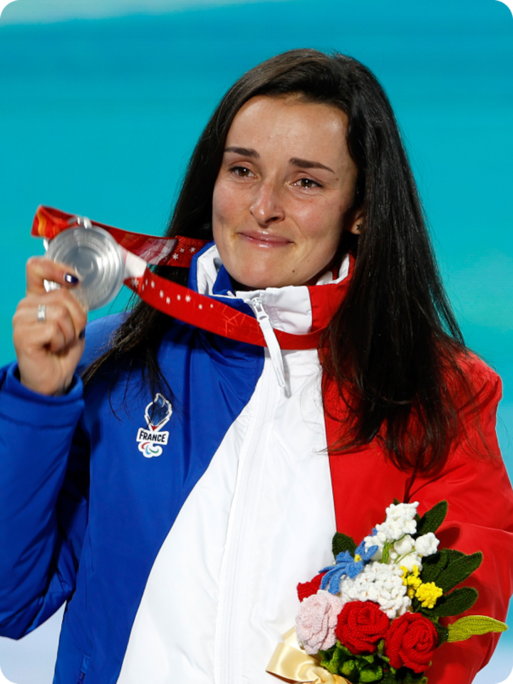 French alpine skier Paralympic Marie Bochet mid-race, flying down the mountain
