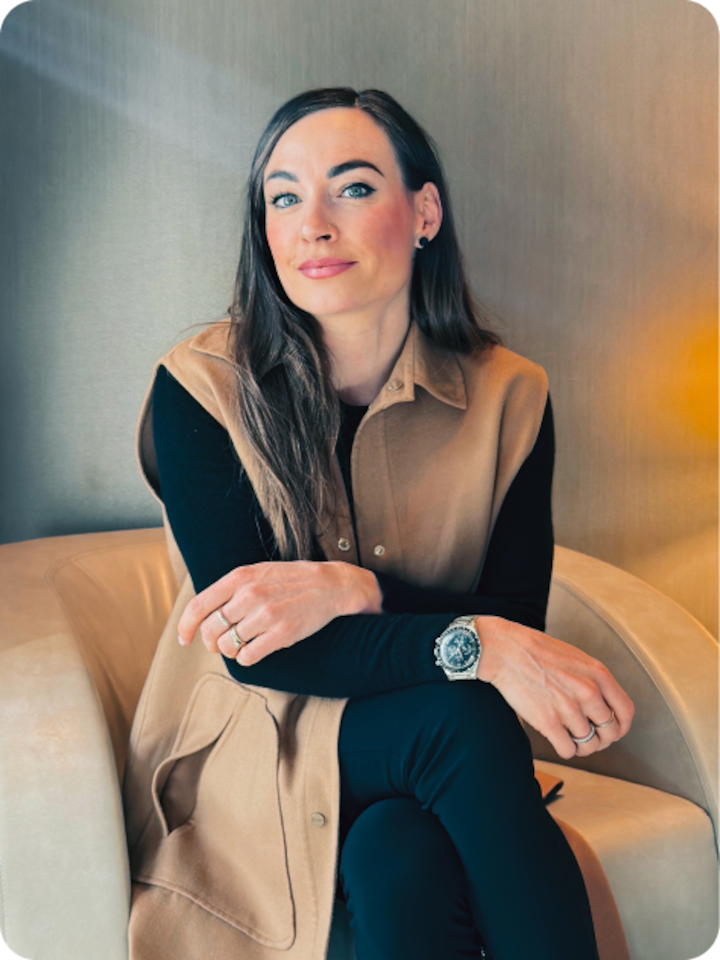 Dorothea Wierer sits in a lounge chair and slightly smiles into camera