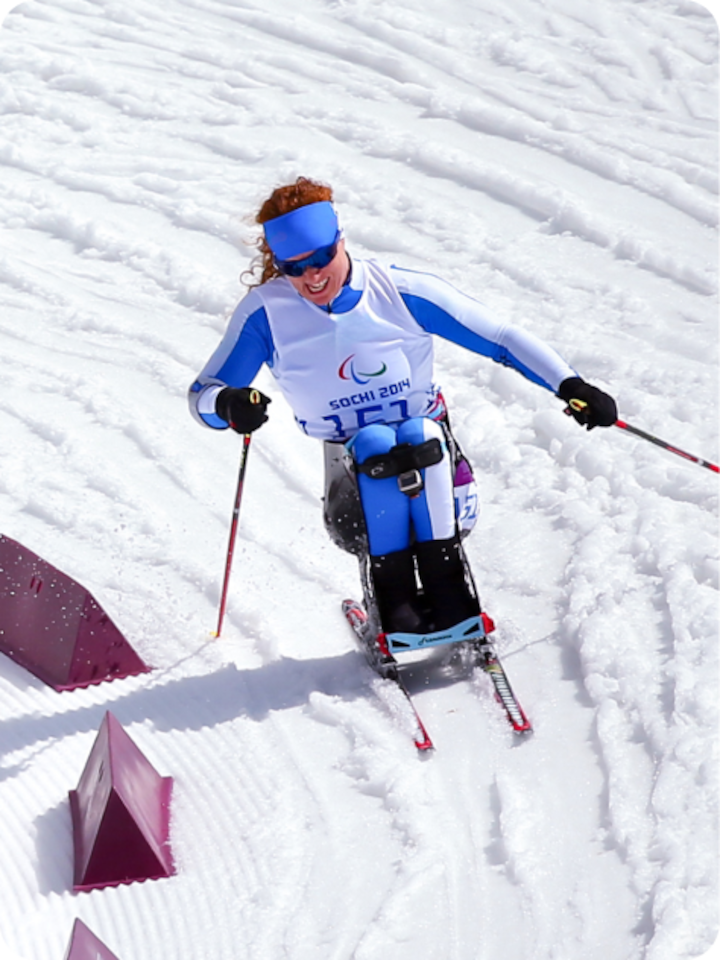 Paralympic skier Francesca Porcellato races down a snowy mountain toward camera