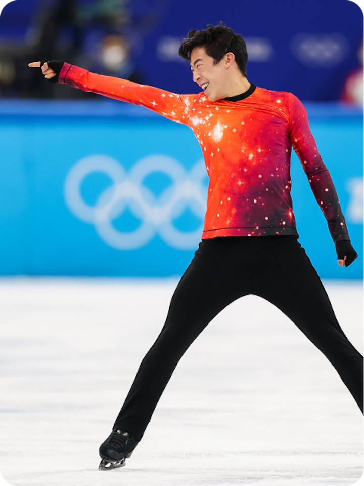 Nathan Chen takes a wide stance and points across the ice in an emphatic end to a routine