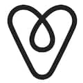 Airbnb logo featuring a minimalist black design resembling an upside-down heart.