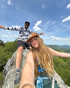 Picture of Aleah and Seth on a rock with a scenic view behind them.