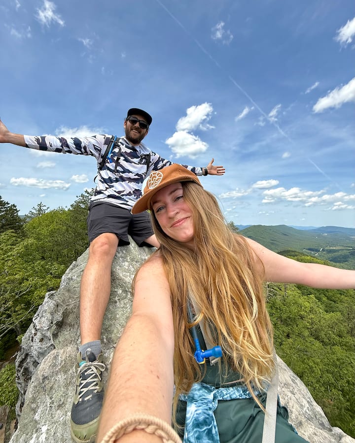 Picture of Aleah and Seth on a rock with a scenic view behind them.