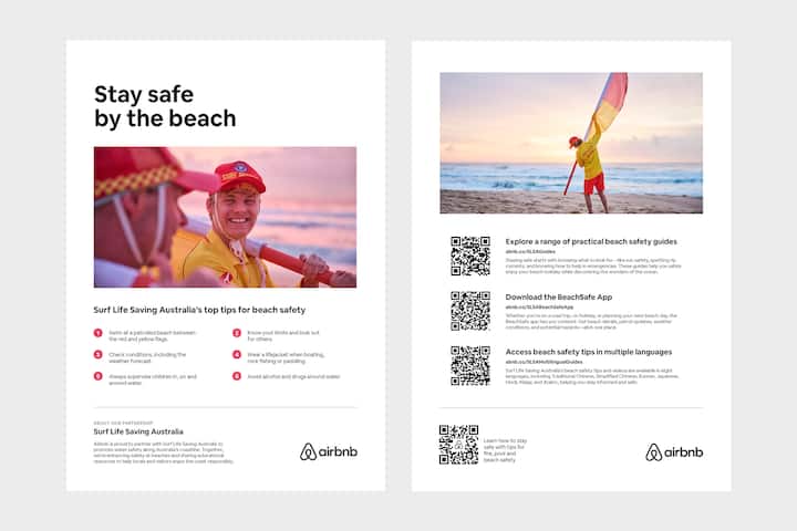 Beach safety flyer featuring a lifeguard at sunrise near a safety flag, with QR codes offering resources like safety guides, multilingual tips, and the BeachSafe app.