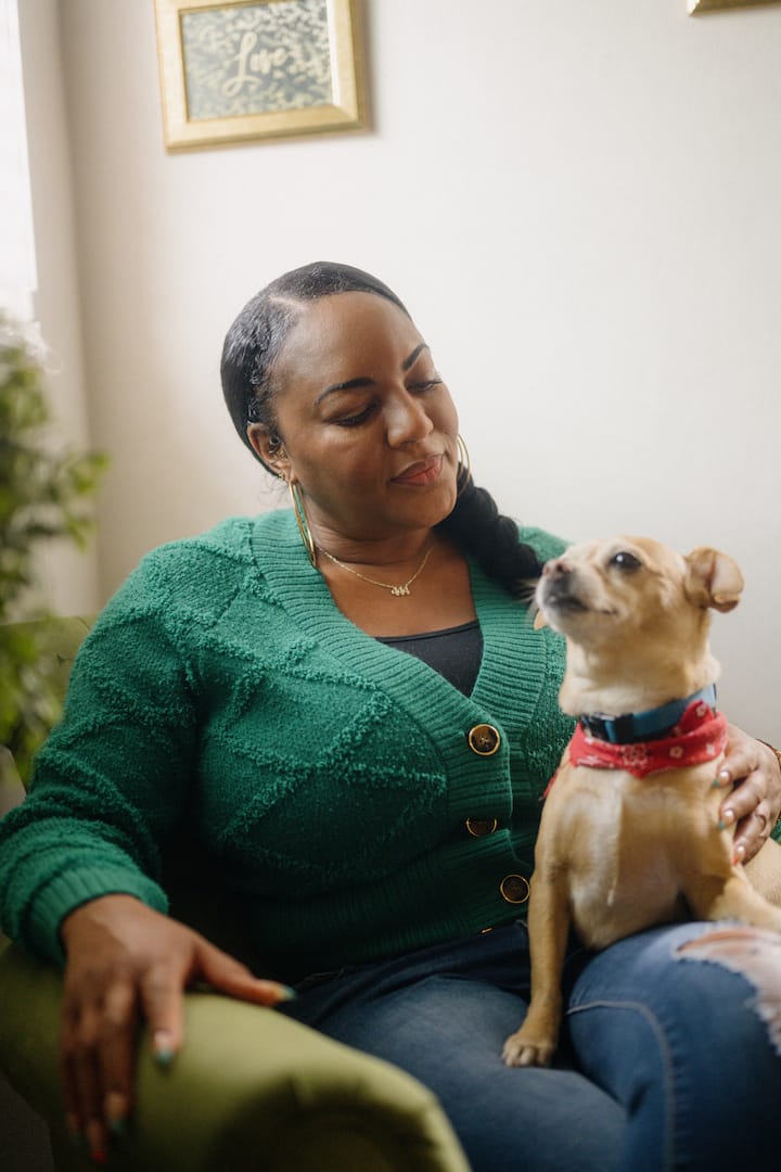 Eshele and her dog King Tut sitting in a chair together