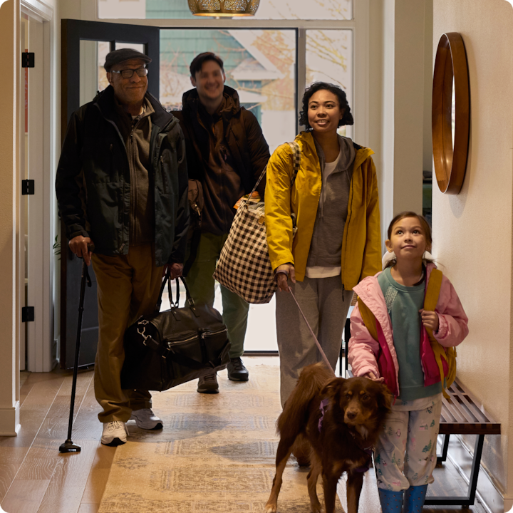 A family enters a warm home after a disaster through a free stay with Airbnb.org.