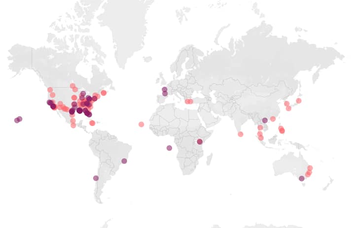 World map with colored dots showing Airbnb.org stays concentrated in the US and spread across major global cities.