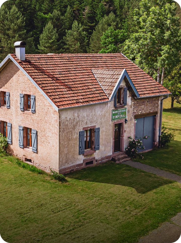 Une maison pittoresque à Mulhouse, avec la mention « Étape 14 Mulhouse » en bas à gauche et une flèche vers la droite.