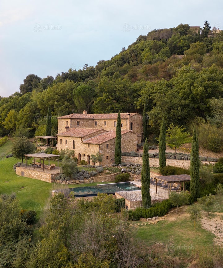 Rural stone villa with pool and terraces nestled in green hills, suggesting tourism beyond crowded city centers