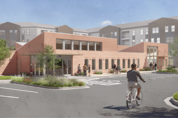 A render of a modern housing complex with public green spaces and walking paths.