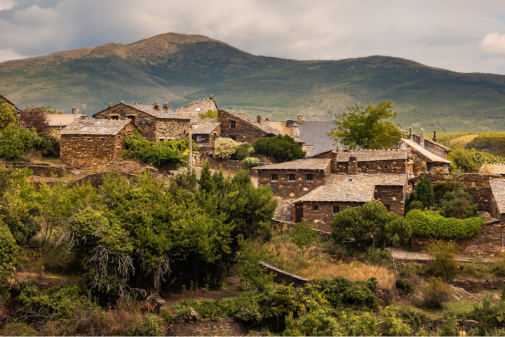 A photo featuring the stone buildings of a rural town in the hills of Spain.