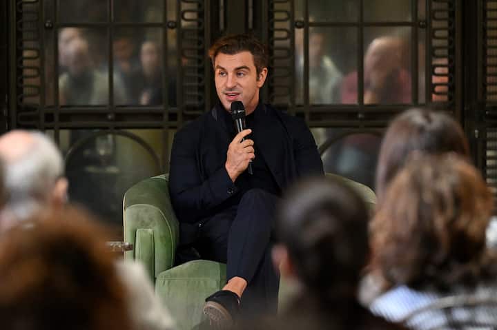A photo of Brian Chesky speaking to an audience.