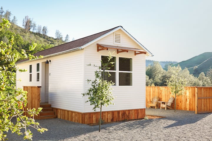 A photo of a home in California with hills in the background.