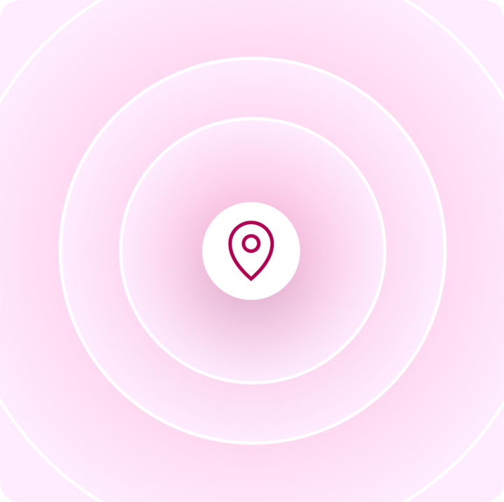 A location pin icon centered in a white circle with concentric rings radiating outward on a soft pink gradient background.