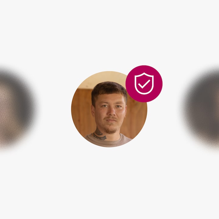 A profile photo of a man with a verification badge icon overlaid in the corner.