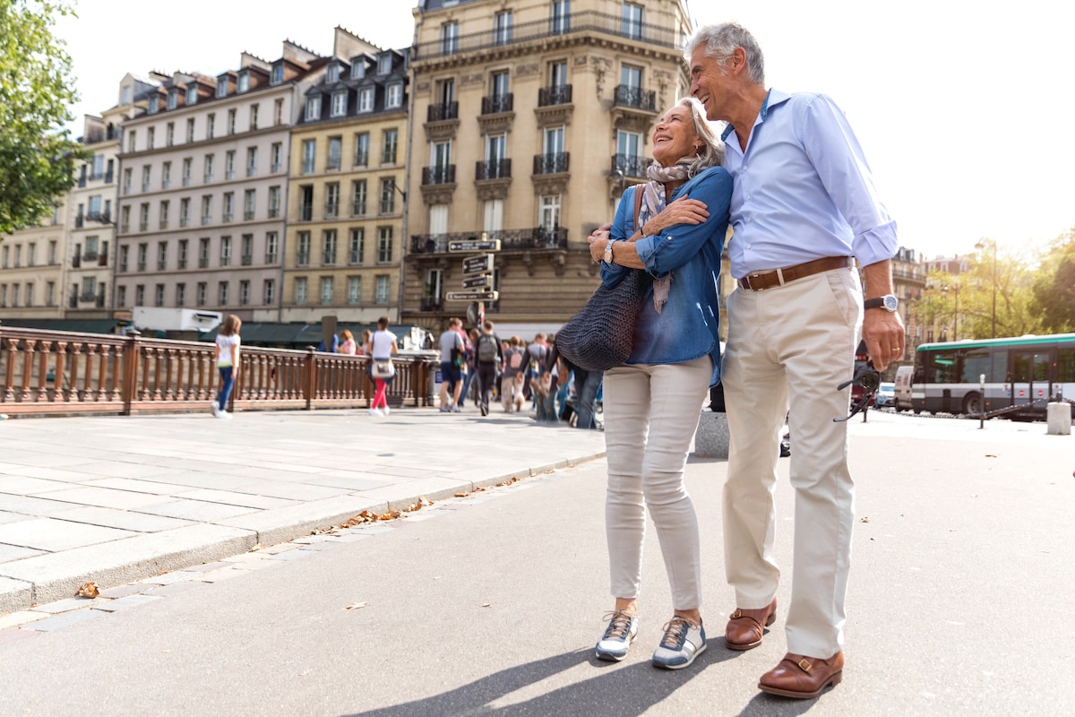 Couple strolling arm in arm along a Paris street