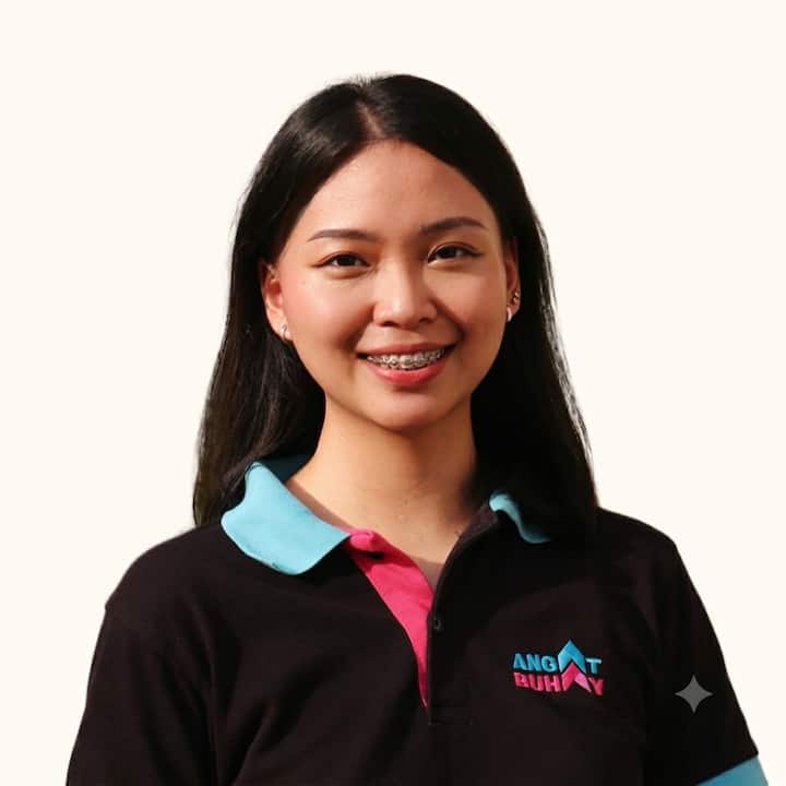 Young woman in an Angat Buhay shirt smiles at the camera against a plain light background.