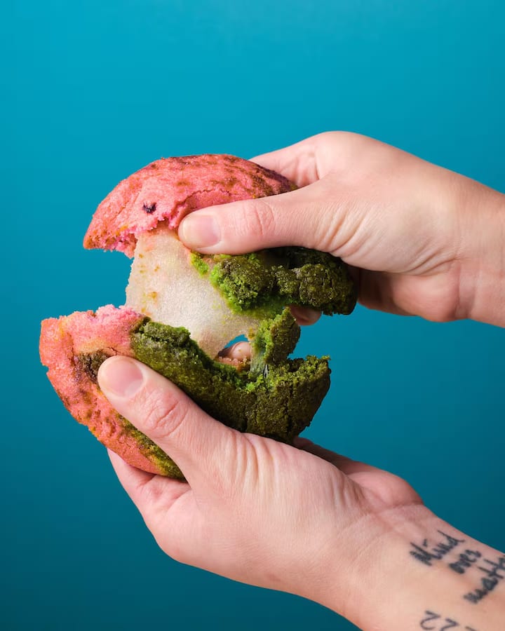 Hands tearing open a colorful cookie