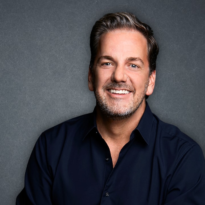 Scott Ramsey, Executive Director of New York Cider Association, smiling against a dark gray backdrop