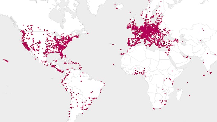 Dots on a world map show locations where Airbnb.org has provided free emergency housing in over 135 countries.