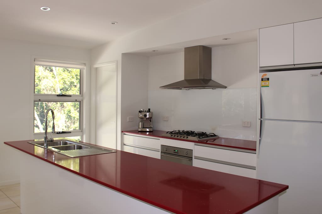Kitchen with coffee machine, oven, gas cooktop, dishwasher, microwave and full size fridge/freezer