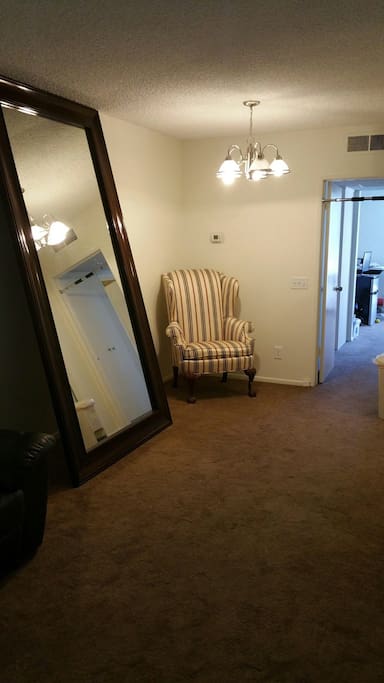 Gigantic mirror to keep you looking sharp, neighboring the perfect reading chair.