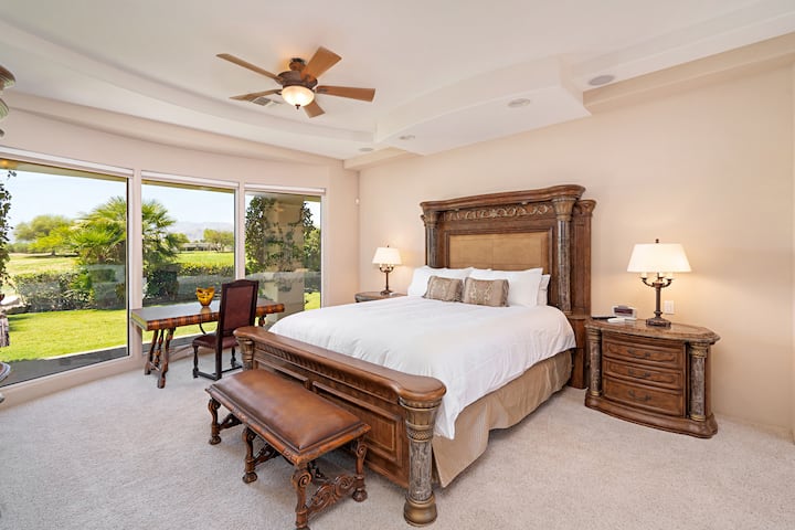 The Master Bedroom has a King sized bed with a large ceiling fan and stunning views