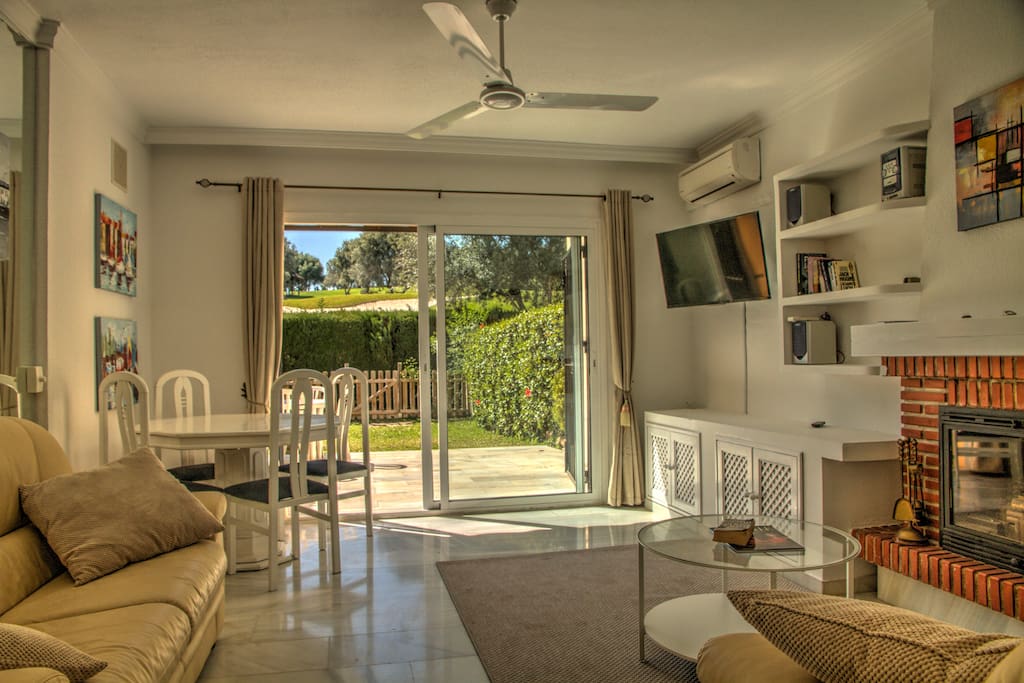 Bright and modern living room with direct access to the private garden and Aloha golf views